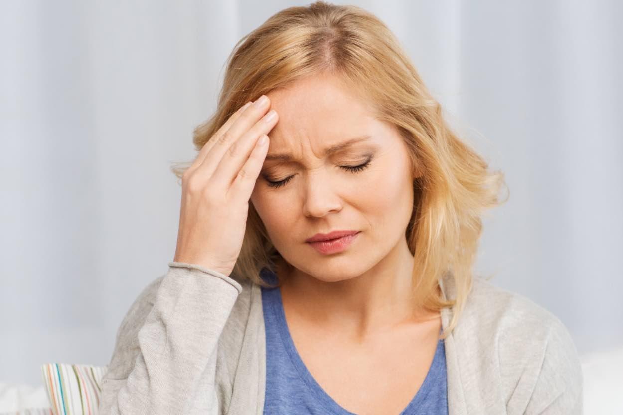 A woman suffering from a headache or migrane